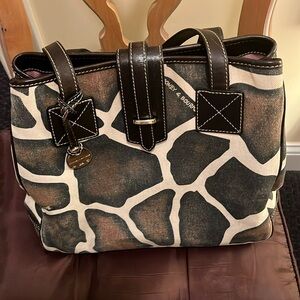 This is a very nice canvas and leather bag with a little wear on the handles.